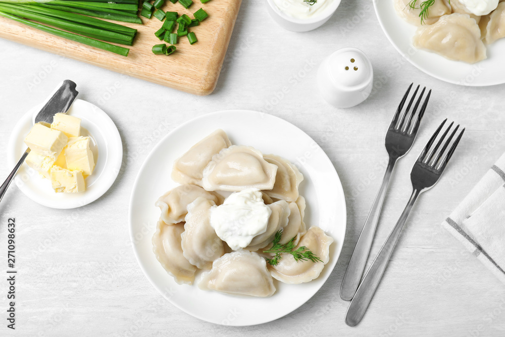 Flat lay composition with tasty dumplings served on white table