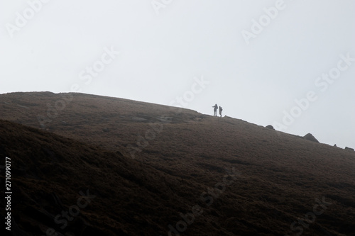 A couple of Hikers on Willaim's clough on the side of Kinder Scout, Peak District, Derbyshire.