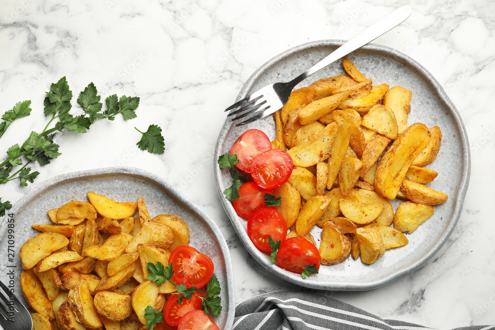 Delicious oven baked potatoes served on table, flat lay Delicious oven baked potatoes served on table, flat lay