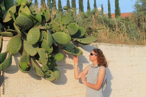 Girl touching opuntia cactus