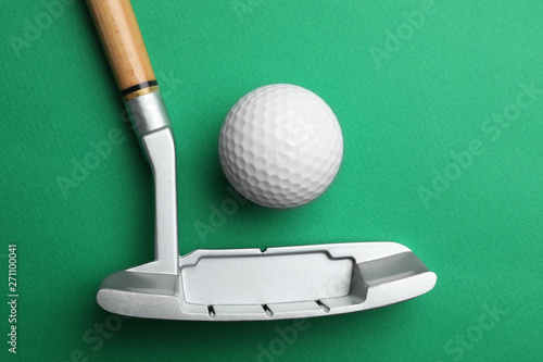 Golf ball and club on color background, flat lay. Sport equipment