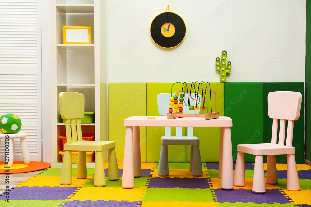 Stylish playroom interior with table and chairs Stylish playroom interior with table and chairs