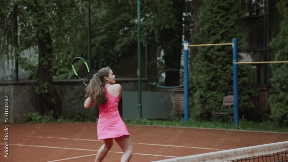Coach assisting sportswoman in playing tennis at tennis court Coach assisting sportswoman in playing tennis at tennis court
