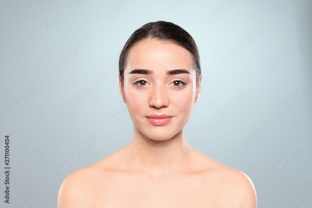 Portrait of young woman with beautiful face against color background Portrait of young woman with beautiful face against color background