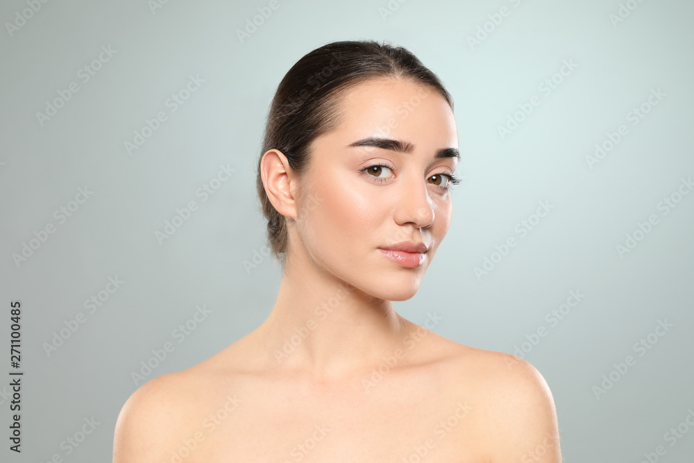 Portrait of young woman with beautiful face against color background Portrait of young woman with beautiful face against color background