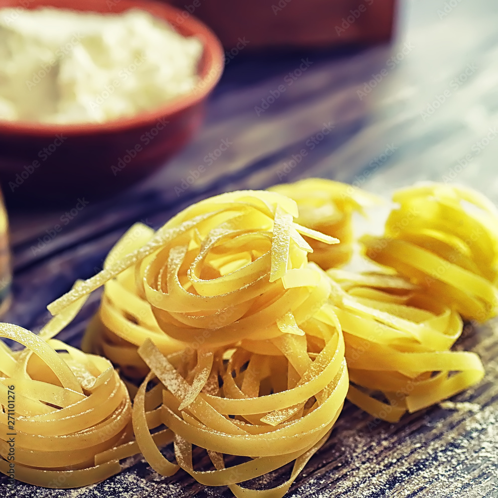 Pasta uncooked on the table. Noodles in the form of nests. Pasta uncooked on the table. Noodles in the form of nests.