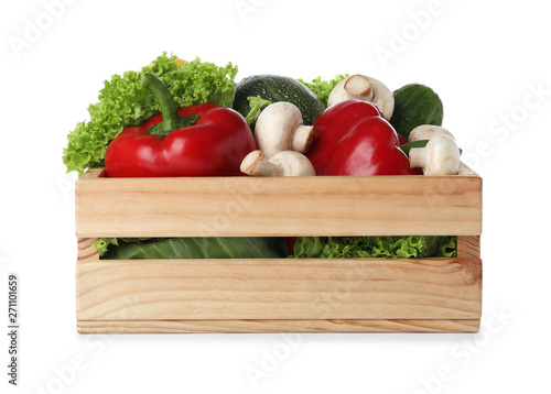 Wooden crate full of fresh ripe vegetables on white background