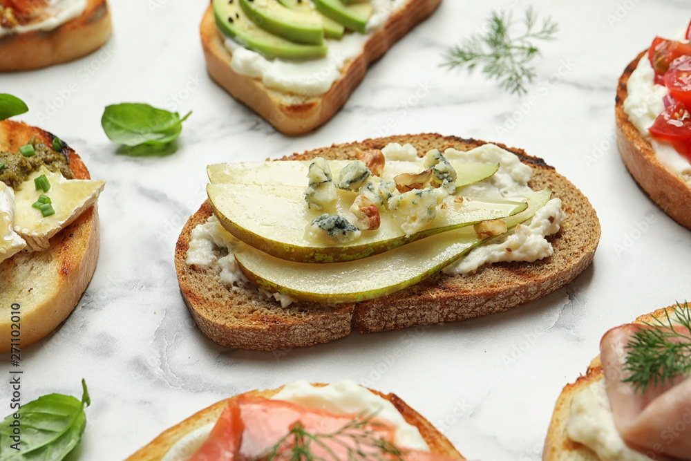 Many different tasty bruschettas on marble table Many different tasty bruschettas on marble table