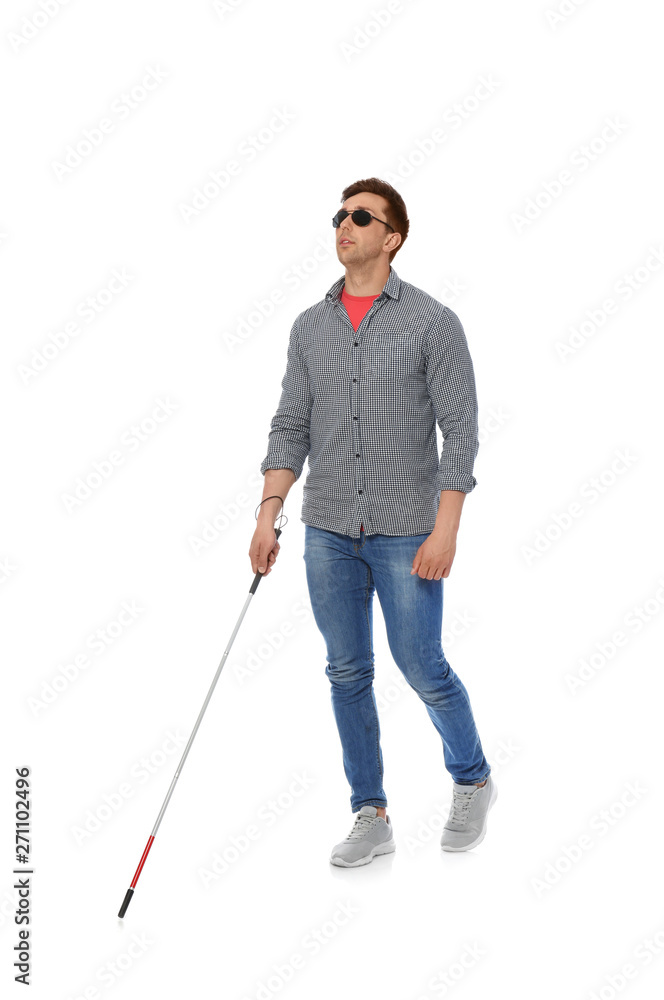 Young blind person with long cane walking on white background Stock Photo