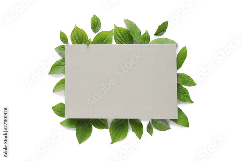 Blank card and spring green leaves on white background, top view. Space for text