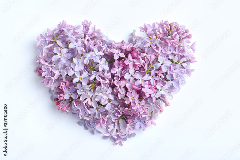 Heart made of blossoming lilac on color background, flat lay. Spring flowers Heart made of blossoming lilac on color background, flat lay. Spring flowers