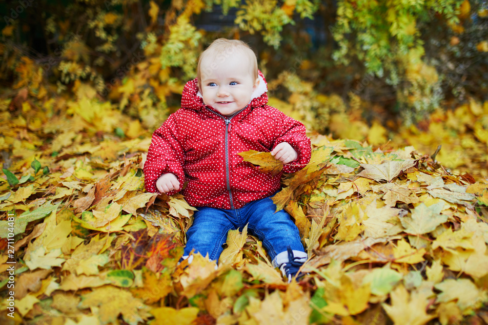 girl sitting in large heap of colorful autumn leaves on a fall day in park girl sitting in large heap of colorful autumn leaves on a fall day in park