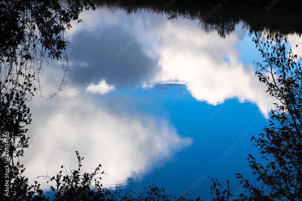 Clouds reflected in water in the Tiber river - Rome, Italy Clouds reflected in water in the Tiber river - Rome, Italy