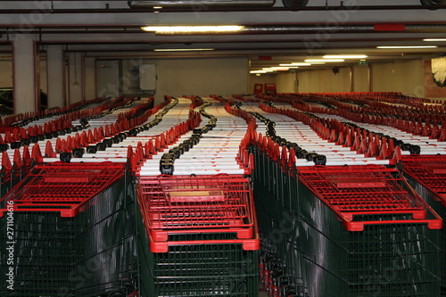 Stacked shopping carts trolley red green supermarket full