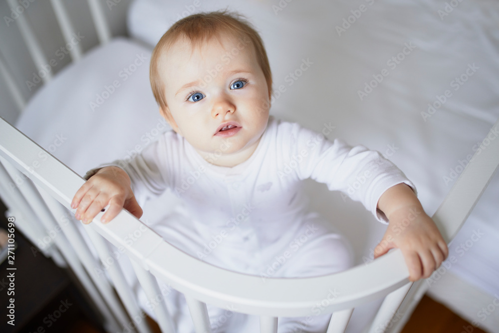 Adorable baby girl in co-sleeper crib Adorable baby girl in co-sleeper crib