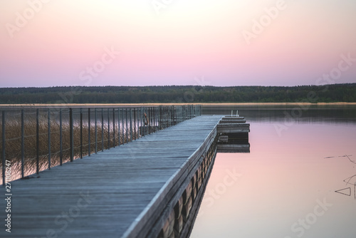 Wallpaper Mural The concept of leisure, a wooden pier on the background of the lake and sunset sky Torontodigital.ca