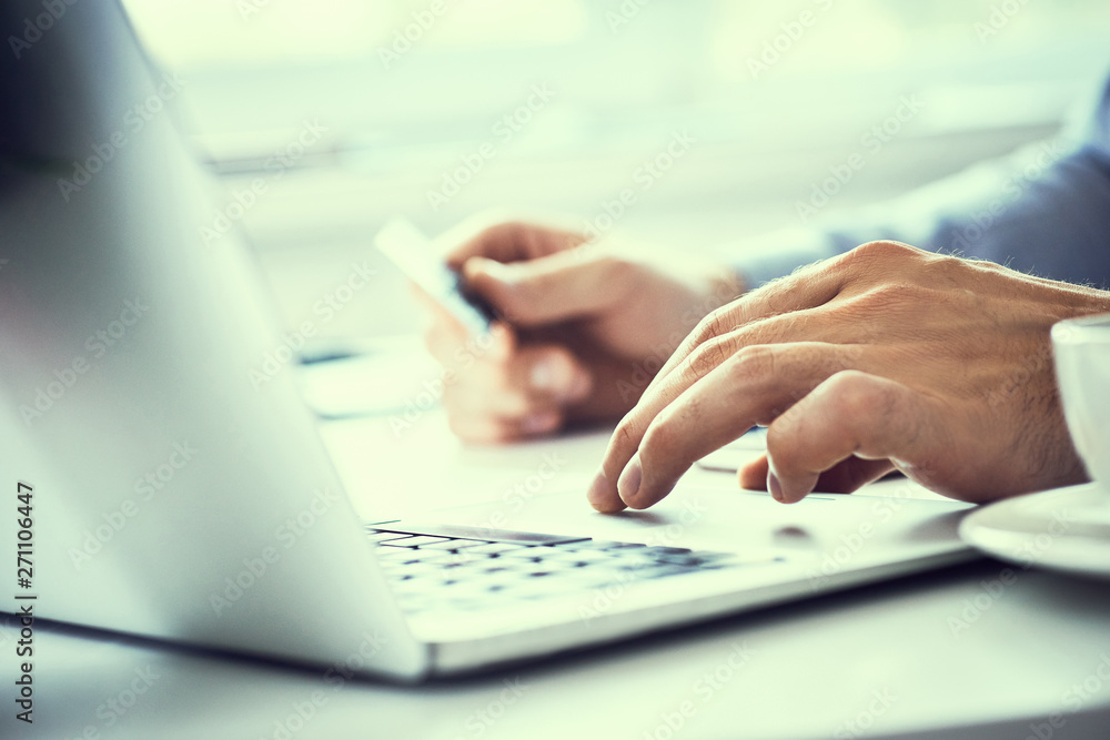 Businessman holding credit card and typing on laptop for online shopping and payment makes a purchase on the Internet. Businessman holding credit card and typing on laptop for online shopping and payment makes a purchase on the Internet.