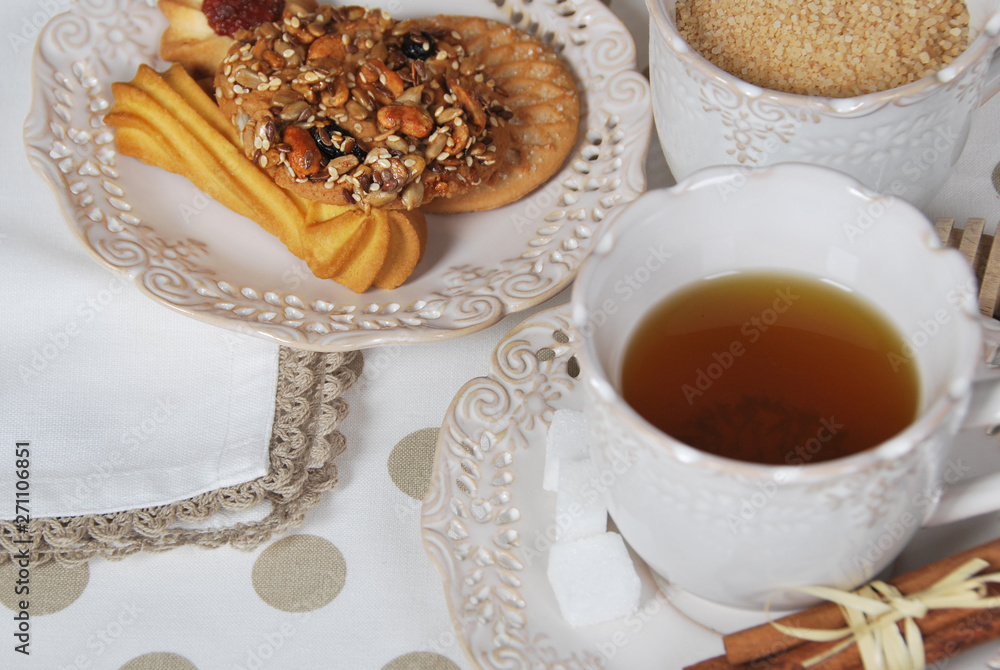 cookies with marmalade, sugar, seeds with tea for breakfast in retro cups cookies with marmalade, sugar, seeds with tea for breakfast in retro cups