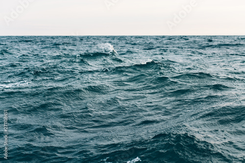 dark blue sea water background, waves of blue in black sea