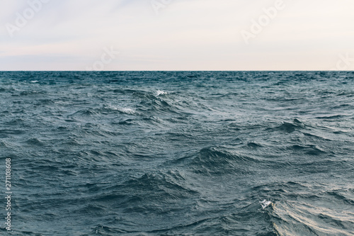 dark blue sea water background, waves of blue in black sea