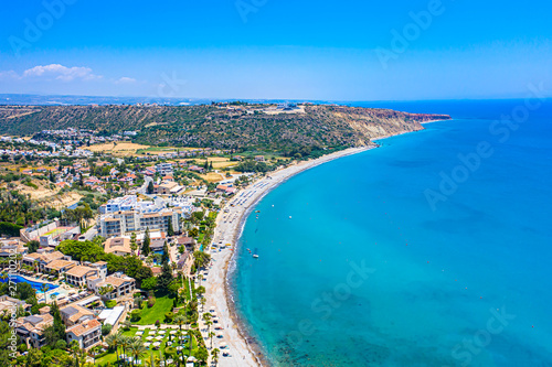 Pissouri. Cyprus. Pissouri beach panorama from a drone. Residential settlements and hotels in the valley at the mountains bottom. The Mediterranean blue lagoon. The Pissouri resort. Travel to Cyprus. © Grispb