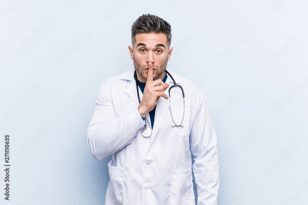Young handsome doctor man keeping a secret or asking for silence. Young handsome doctor man keeping a secret or asking for silence.