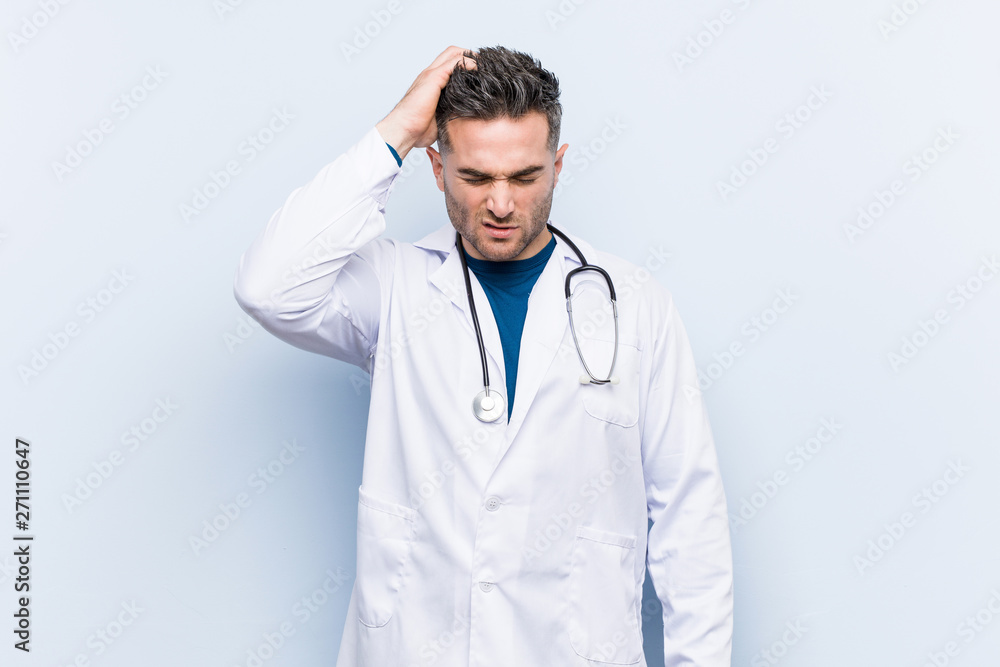 Young handsome doctor man tired and very sleepy keeping hand on head. Young handsome doctor man tired and very sleepy keeping hand on head.