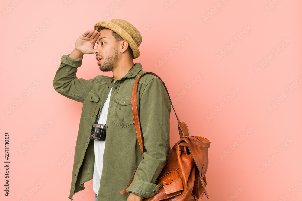 Young filipino traveler man looking far away keeping hand on forehead. Young filipino traveler man looking far away keeping hand on forehead.