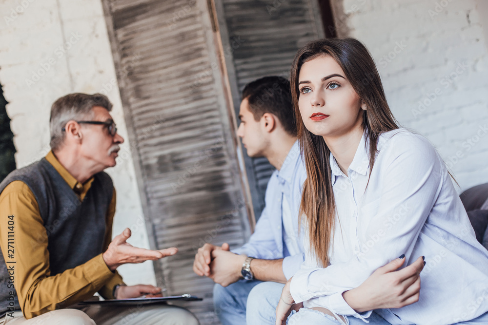 Problems in family. Nice pleasant young couple discussing their problems and having an argument while visiting a psychologist!! Woman thinking! Problems in family. Nice pleasant young couple discussing their problems and having an argument while visiting a psychologist!! Woman thinking!