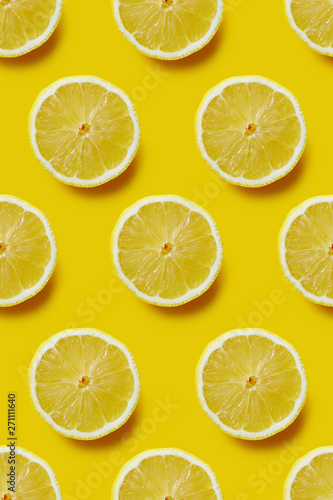 Fresh sliced lemon on yellow background, infinite pattern