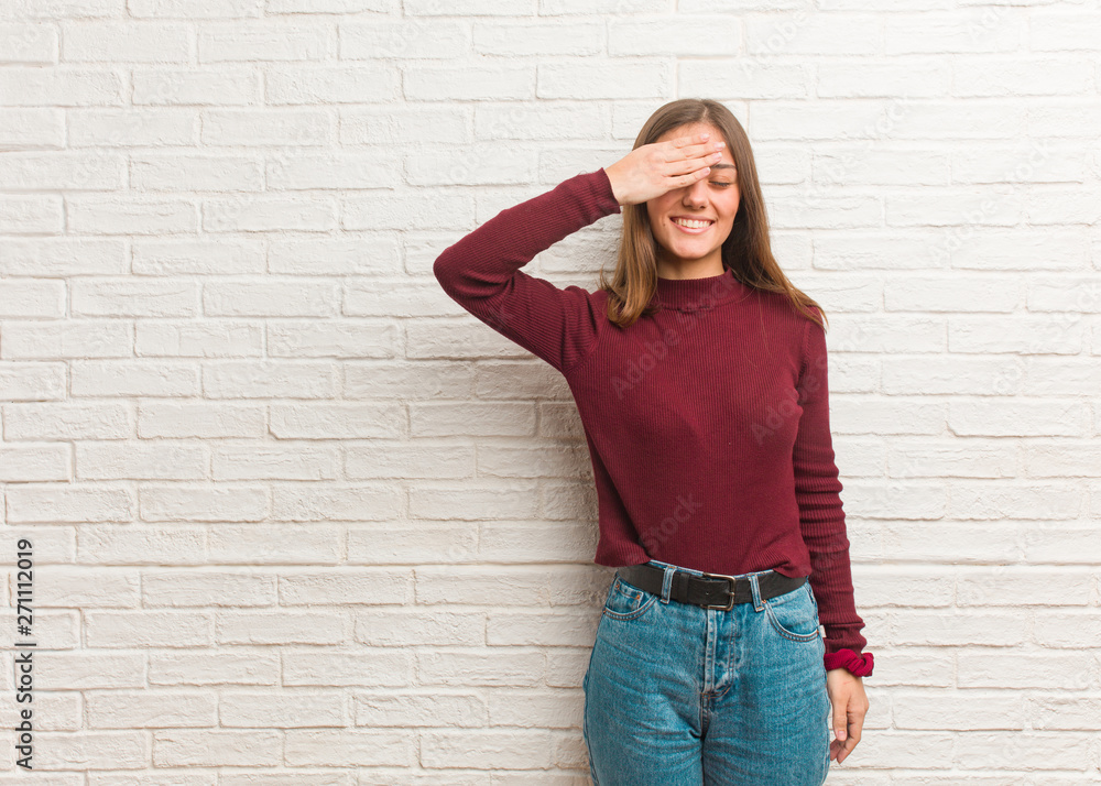 Young cool woman over a bricks wall forgetful, realize something Young cool woman over a bricks wall forgetful, realize something