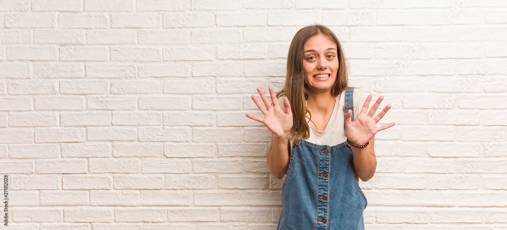 Young hipster woman rejecting something doing a gesture of disgust Young hipster woman rejecting something doing a gesture of disgust