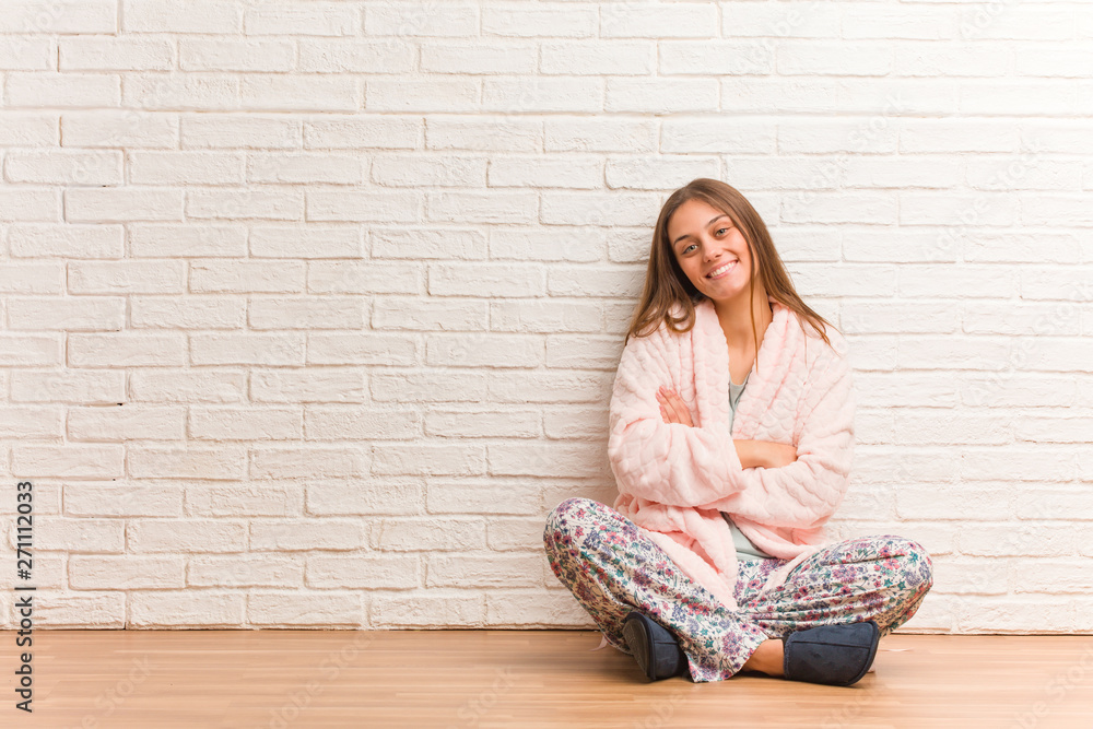 Young woman wearing pajama crossing arms, smiling and relaxed Young woman wearing pajama crossing arms, smiling and relaxed