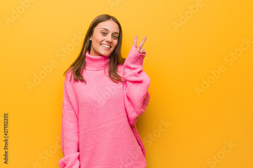 Young modern woman fun and happy doing a gesture of victory
