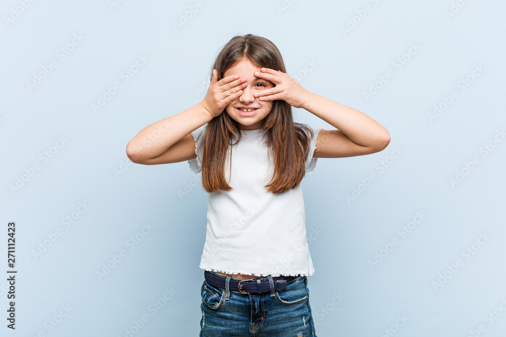 Cute girl blink through fingers frightened and nervous. Cute girl blink through fingers frightened and nervous.