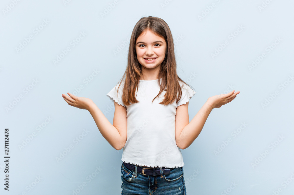 Cute girl makes scale with arms, feels happy and confident. Cute girl makes scale with arms, feels happy and confident.