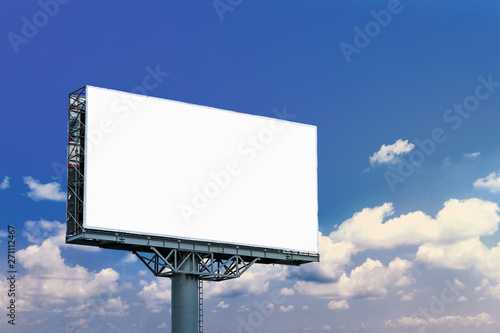 Blank billboard mockup with white screen against clouds and blue sky background. Copy space banner for advertisement. Business Concept. photo