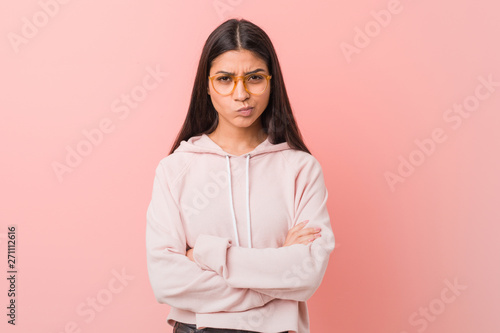 Young pretty arab woman wearing a casual sport look frowning face in displeasure, keeps arms folded. © Asier