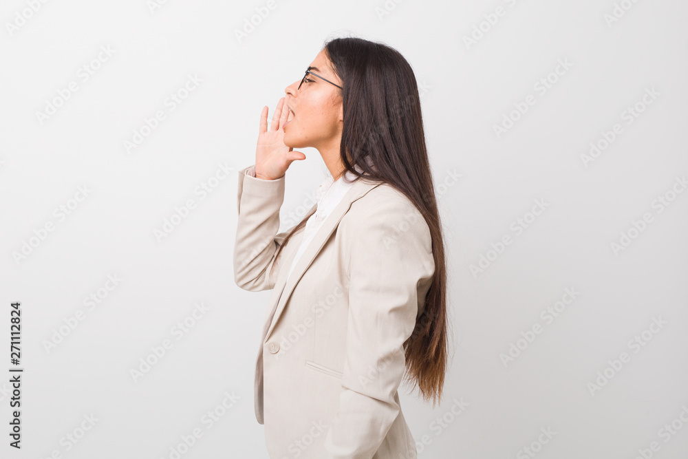 Young business arab woman isolated against a white background shouting and holding palm near opened mouth. Young business arab woman isolated against a white background shouting and holding palm near opened mouth.