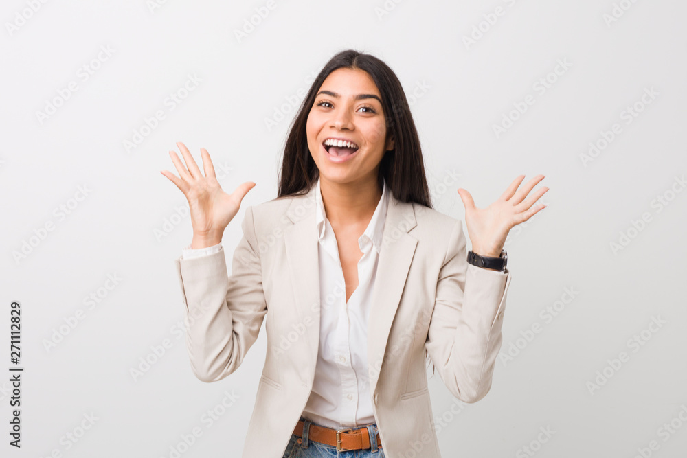 Young business arab woman isolated against a white background celebrating a victory or success, he is surprised and shocked. Young business arab woman isolated against a white background celebrating a victory or success, he is surprised and shocked.