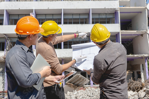 Engineer team and worker checking blueprint for emolition construction plan and inspect at the site.