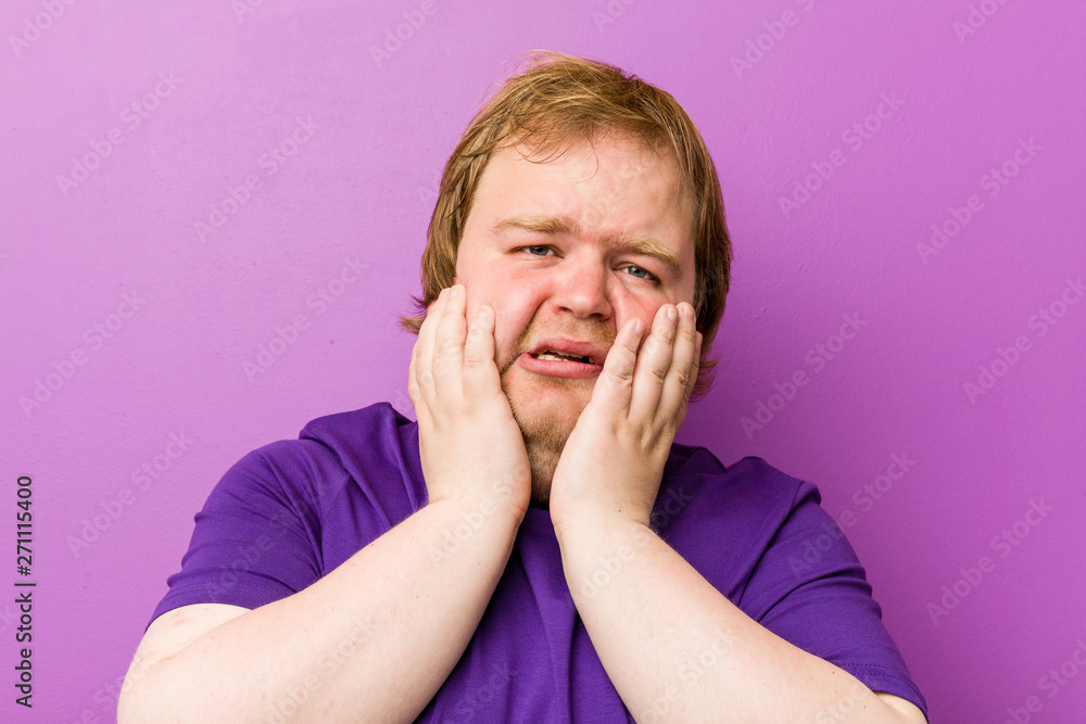 Young authentic redhead fat man whining and crying disconsolately. Young authentic redhead fat man whining and crying disconsolately.