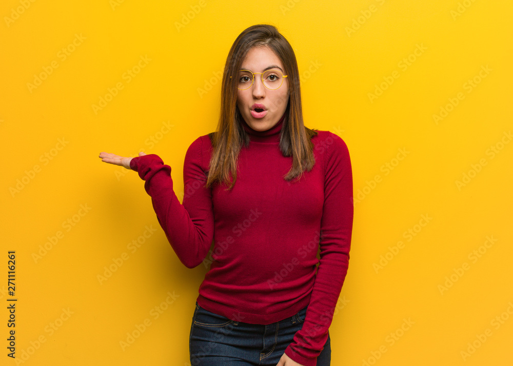 Young intellectual woman holding something on palm hand Young intellectual woman holding something on palm hand
