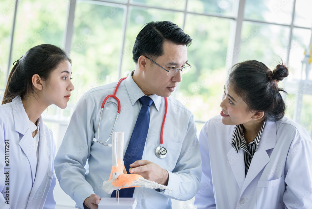 Asian teacher has teaching to student about science and anatomical in laboratory Asian teacher has teaching to student about science and anatomical in laboratory