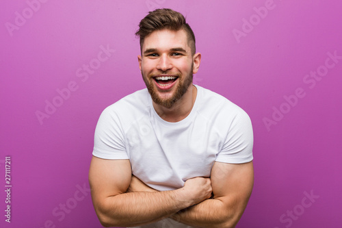 Young handsome caucasian man laughing and having fun.