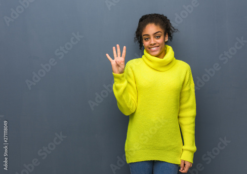 Young black woman showing number four photo