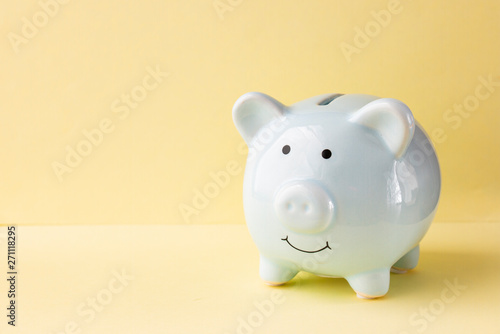 Piggy bank blue on a yellow background