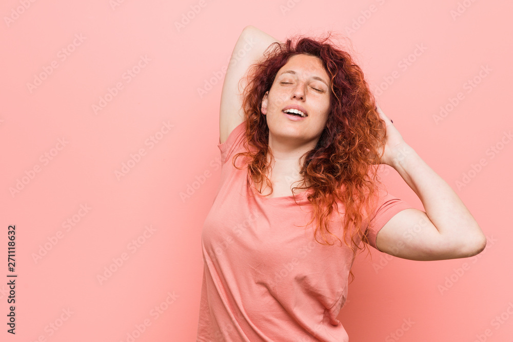 Young natural and authentic redhead woman stretching arms, relaxed position. Young natural and authentic redhead woman stretching arms, relaxed position.