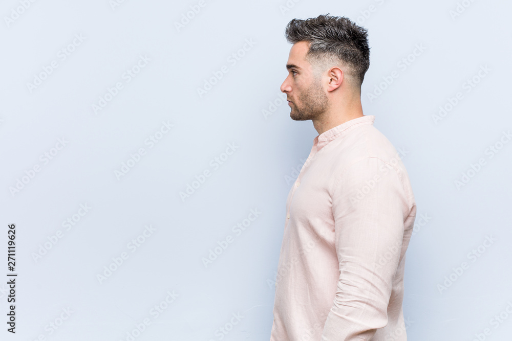 Young handsome cool man gazing left, sideways pose. Young handsome cool man gazing left, sideways pose.