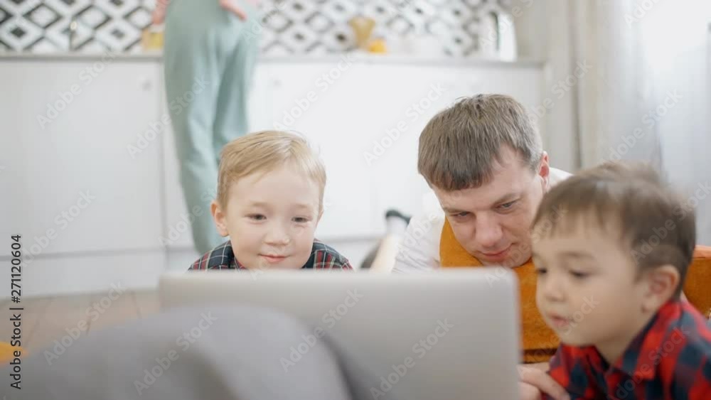 Calm father spending free time together with his little kids Calm father spending free time together with his little kids